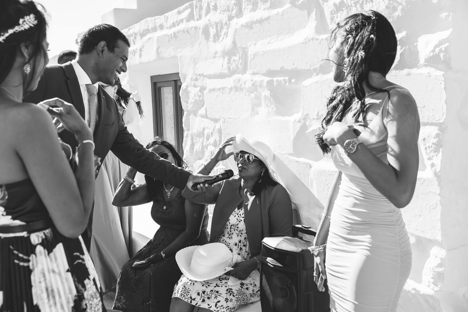 Guests laughing after a wedding at  Pyrgaki chapeli in Paros Greece