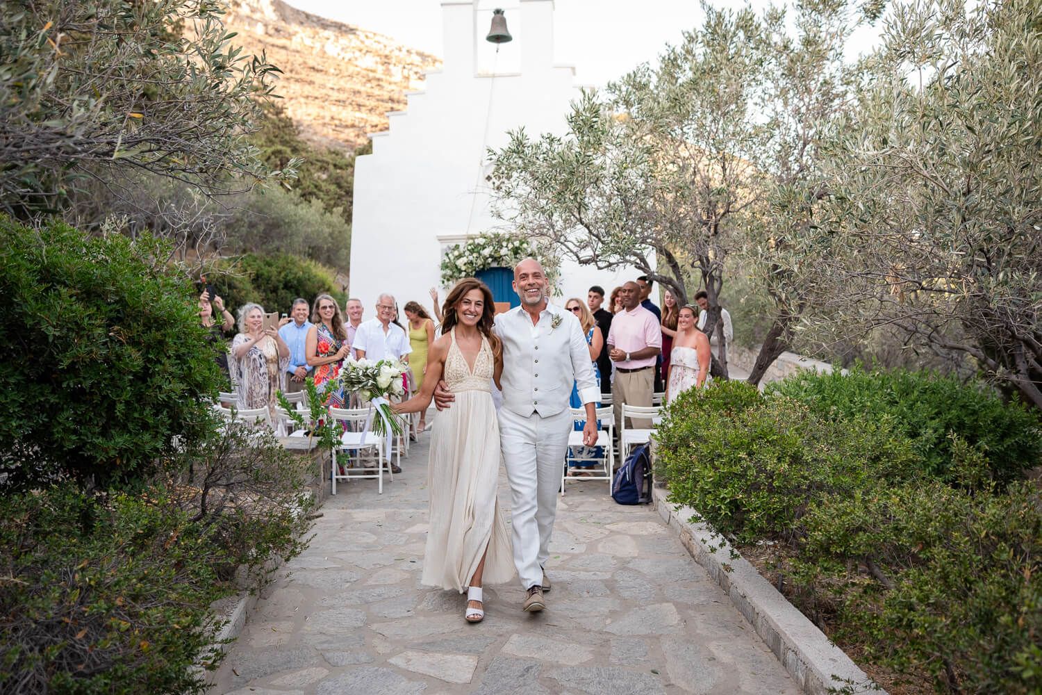 Joyful newlyweds walking together after their small wedding ceremony