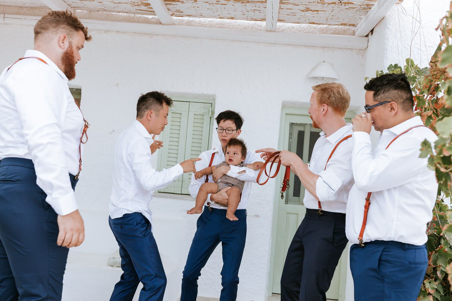 Groom holding his baby boy - Family wedding photography