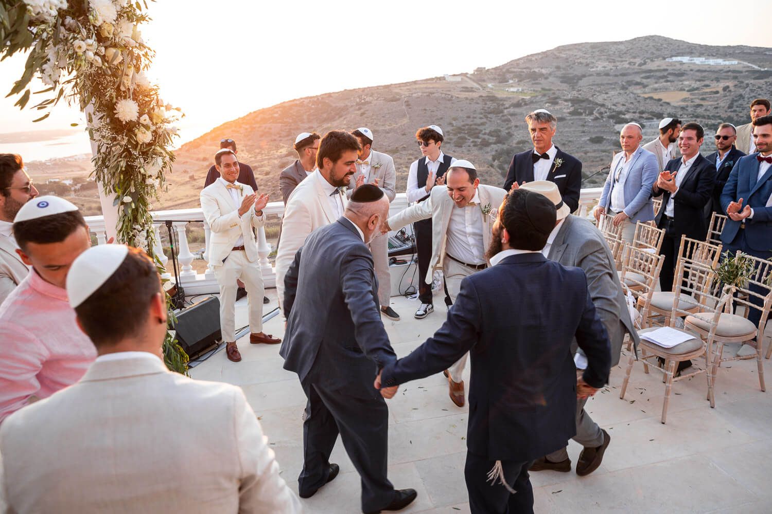 Guests dancing in circles for the traditional Hora at Paros wedding