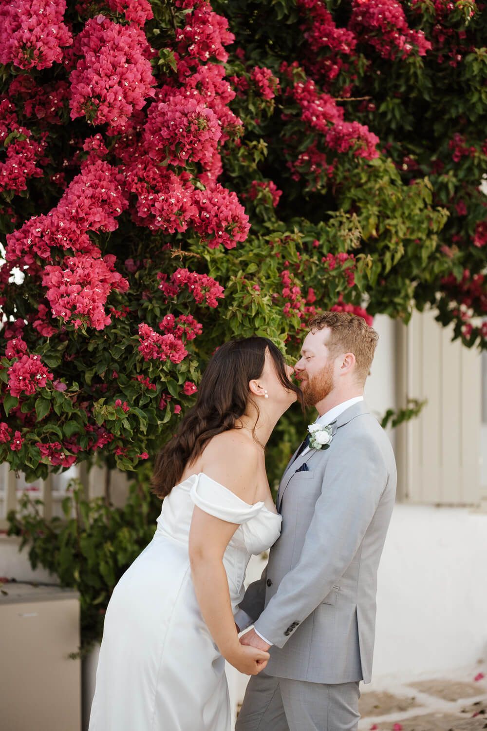Wedding portraits with bougainvillea and white walls