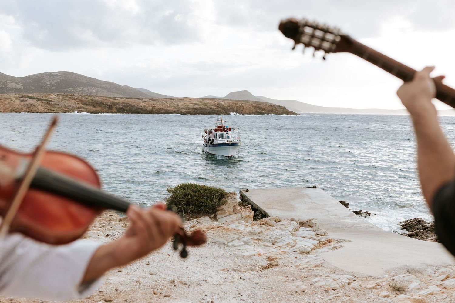 Bride arriving by traditional kaiki boat in Antiparos