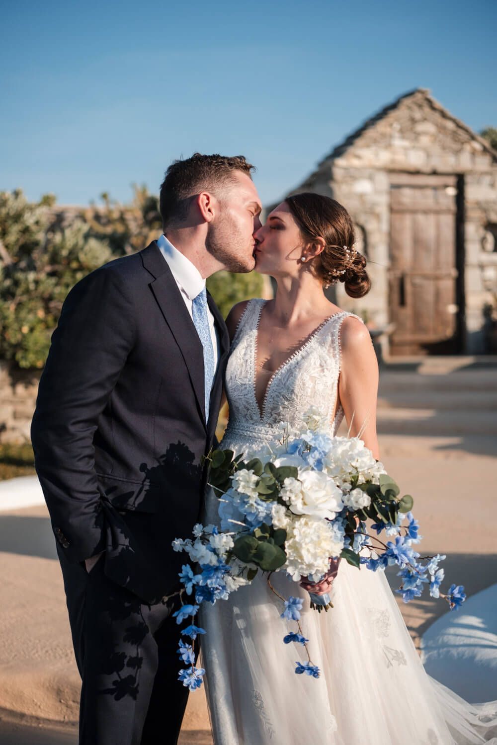 Newlyweds sharing their first kiss as husband and wife at a luxury villa