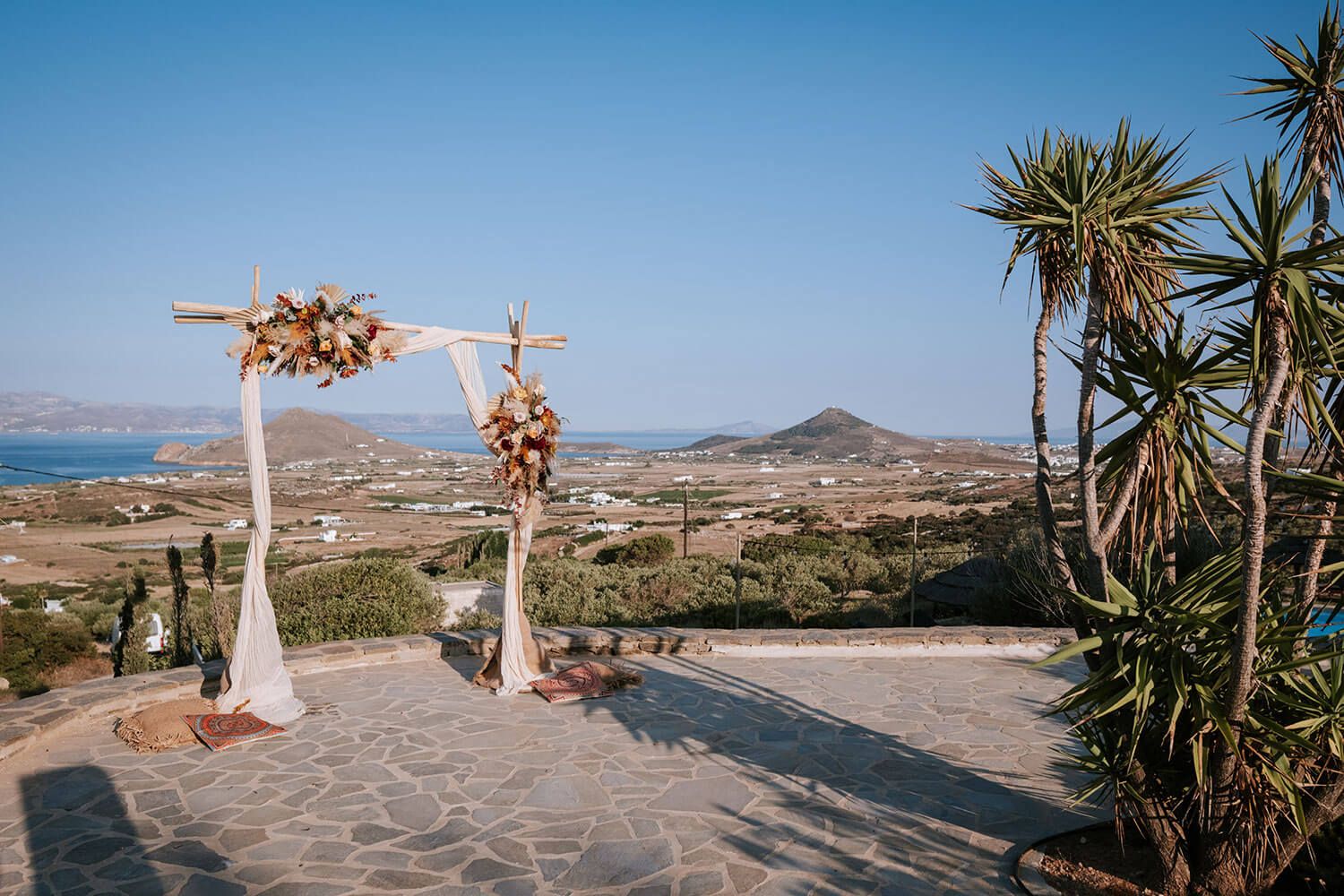 Rustic wooden wedding arch with beautiful floral arrangements in Greece