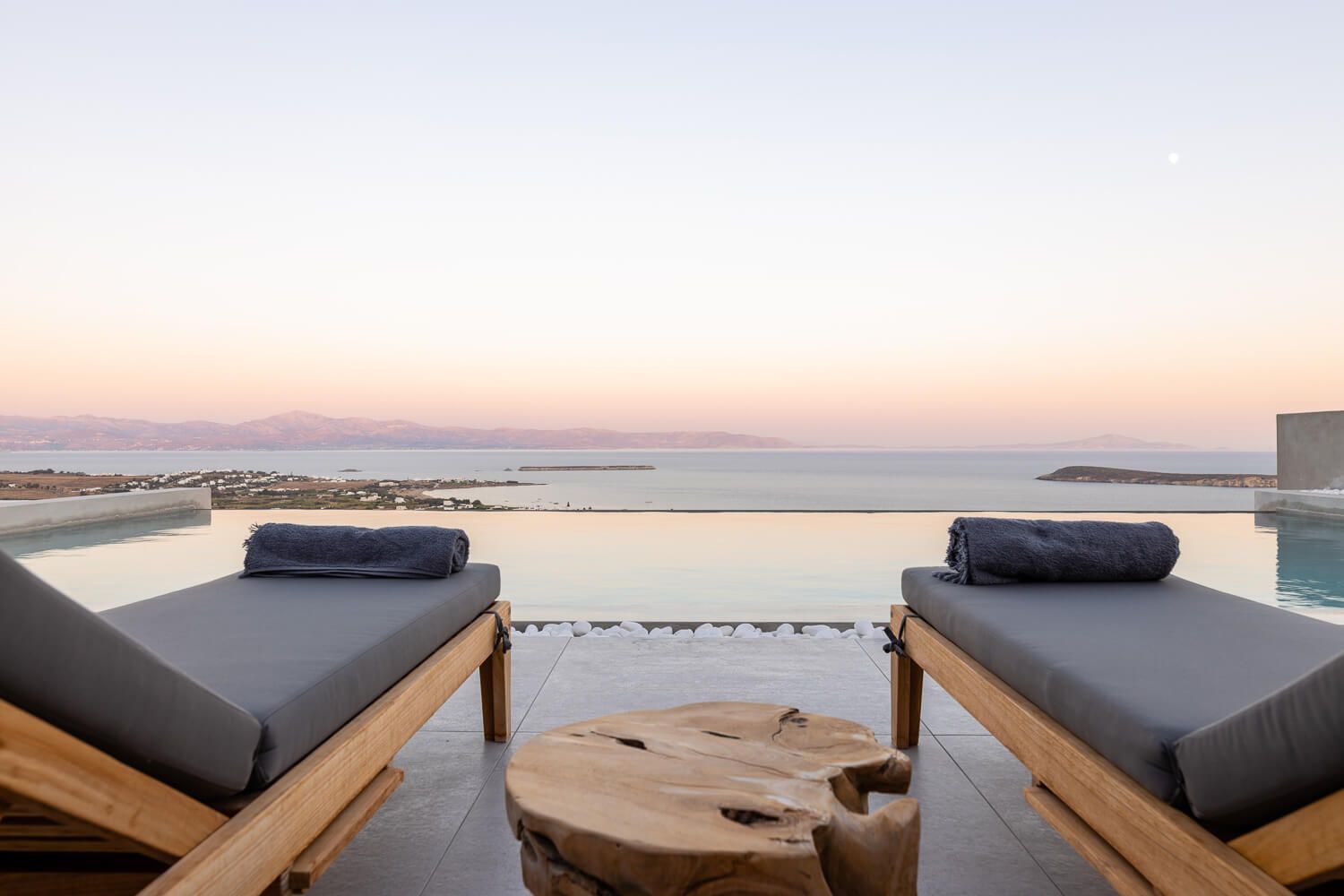 Luxury pool area styling designed for complete relaxation with a magnificent view to Naxos island.
