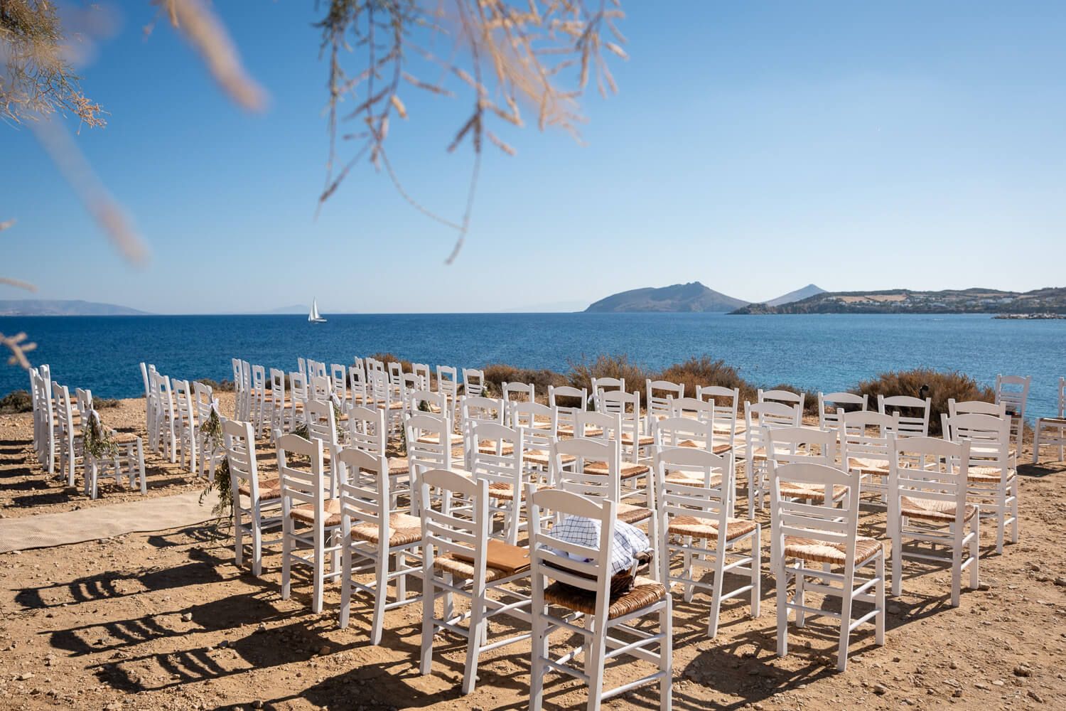 Custom wedding ceremony setup on the coastal rocks of Ambelas, Paros