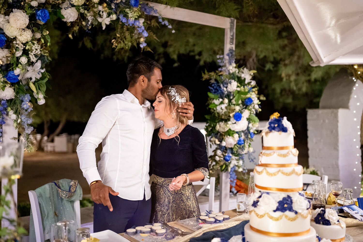 Joyful cake cutting moment during a spectacular Paros destination wedding