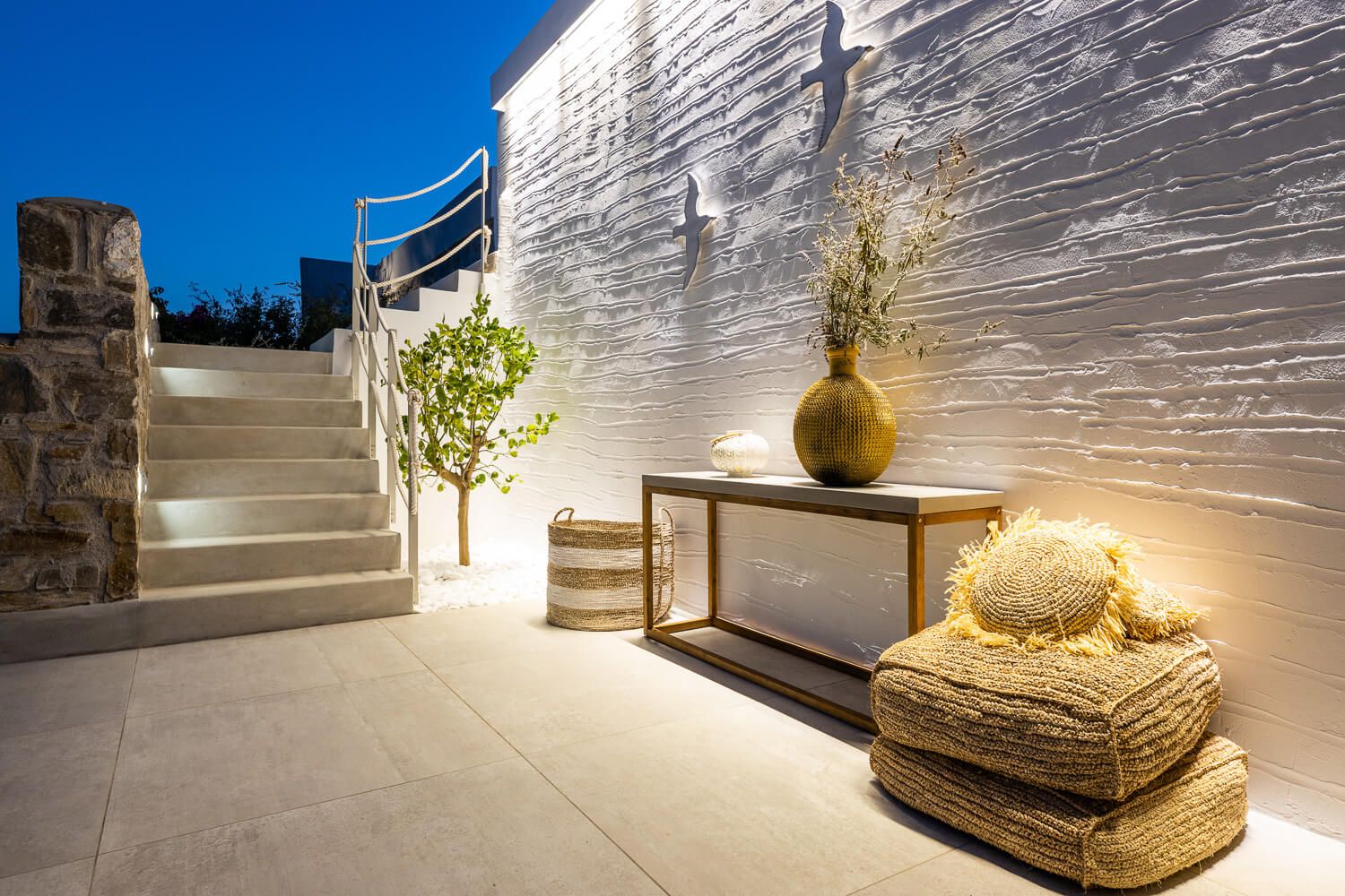 Premium outdoor furniture selection on a terrace at dusk