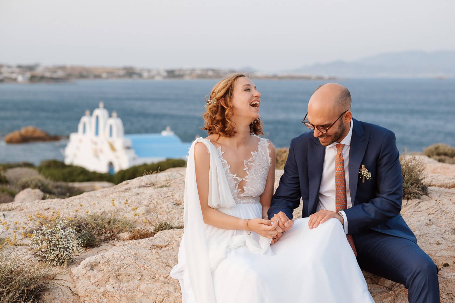 Dimitris and Ioanna laughing during a portrait session after their ceremony in Pyrgaki chapel