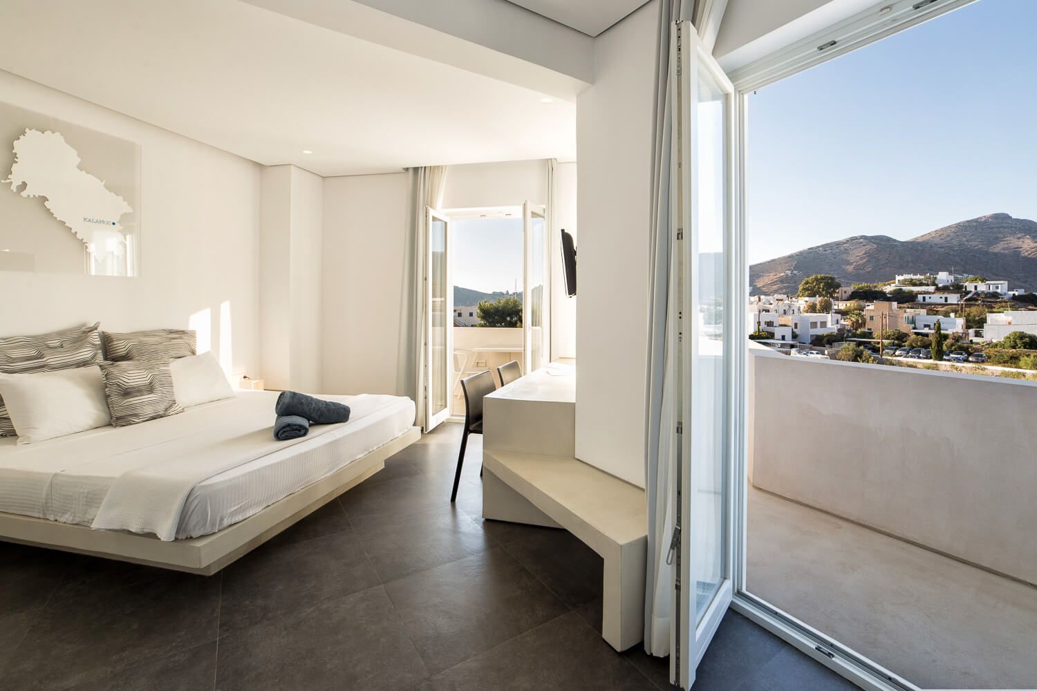Natural light illuminating the crisp white walls of a boutique room