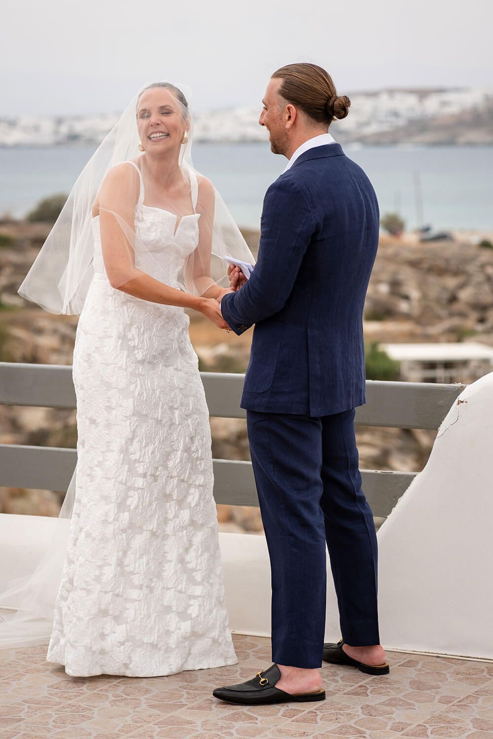 Couple holding hands during their intimate wedding ceremony in Paros