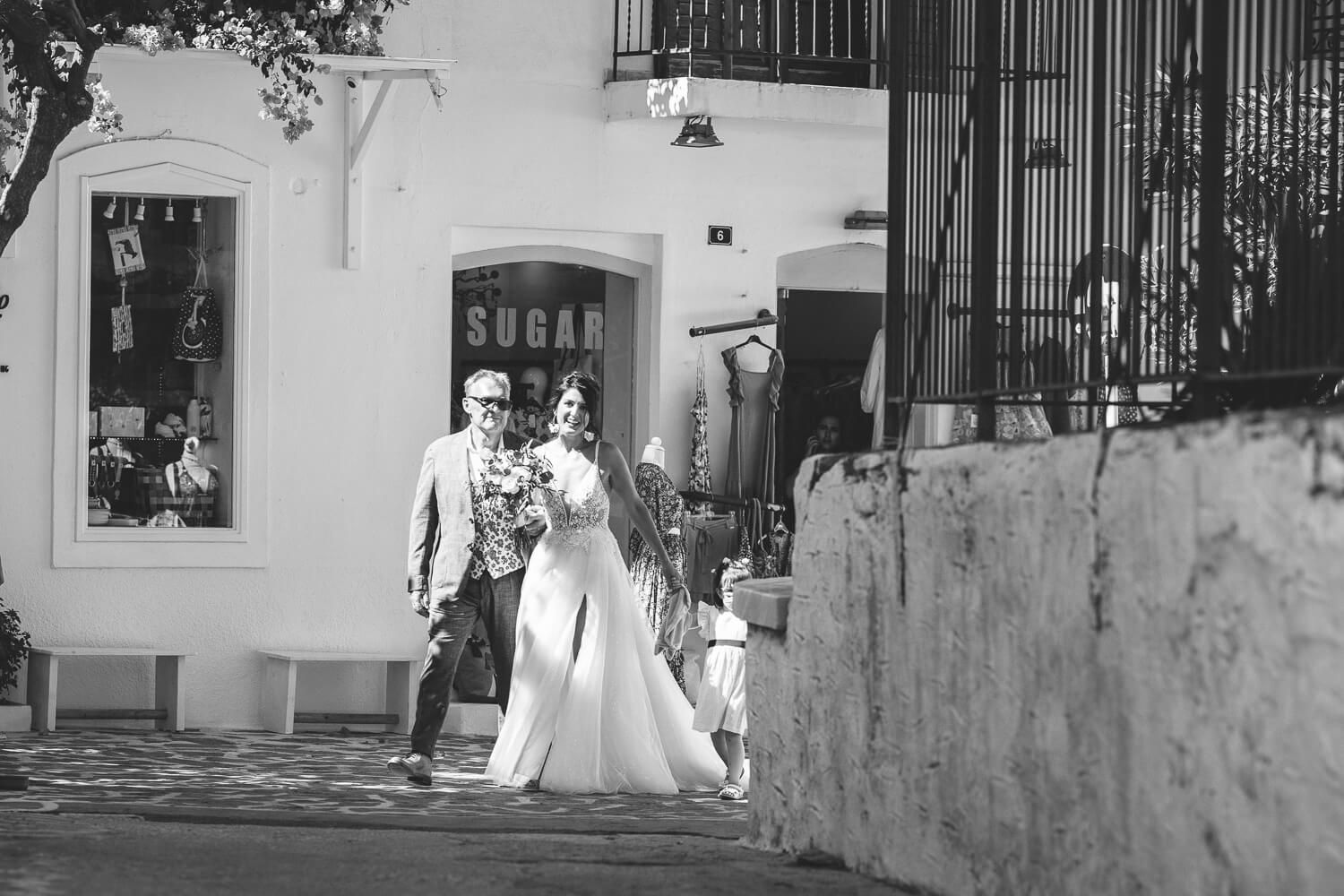 Bride walking towards the church through the narrow streets of Parikia