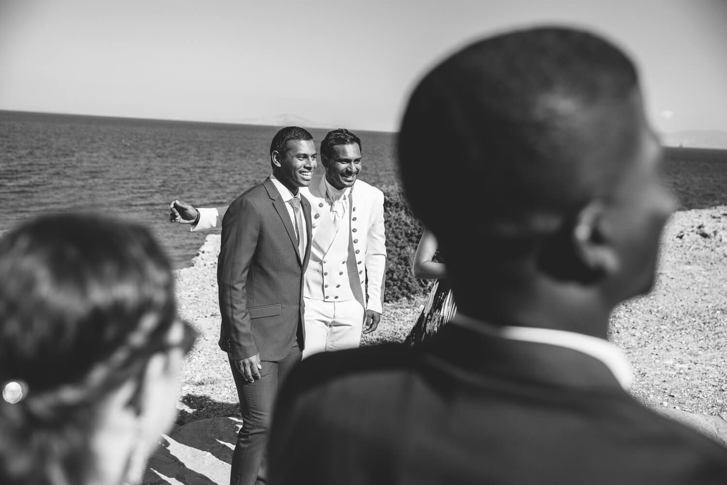 Guests laughing after a wedding at  Pyrgaki chapeli in Paros Greece