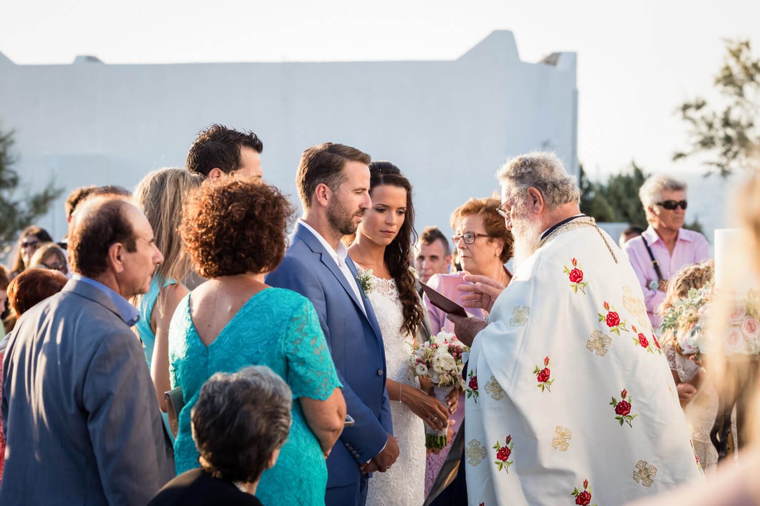 Spanish-Greek wedding ceremony in a white chapel in Milos