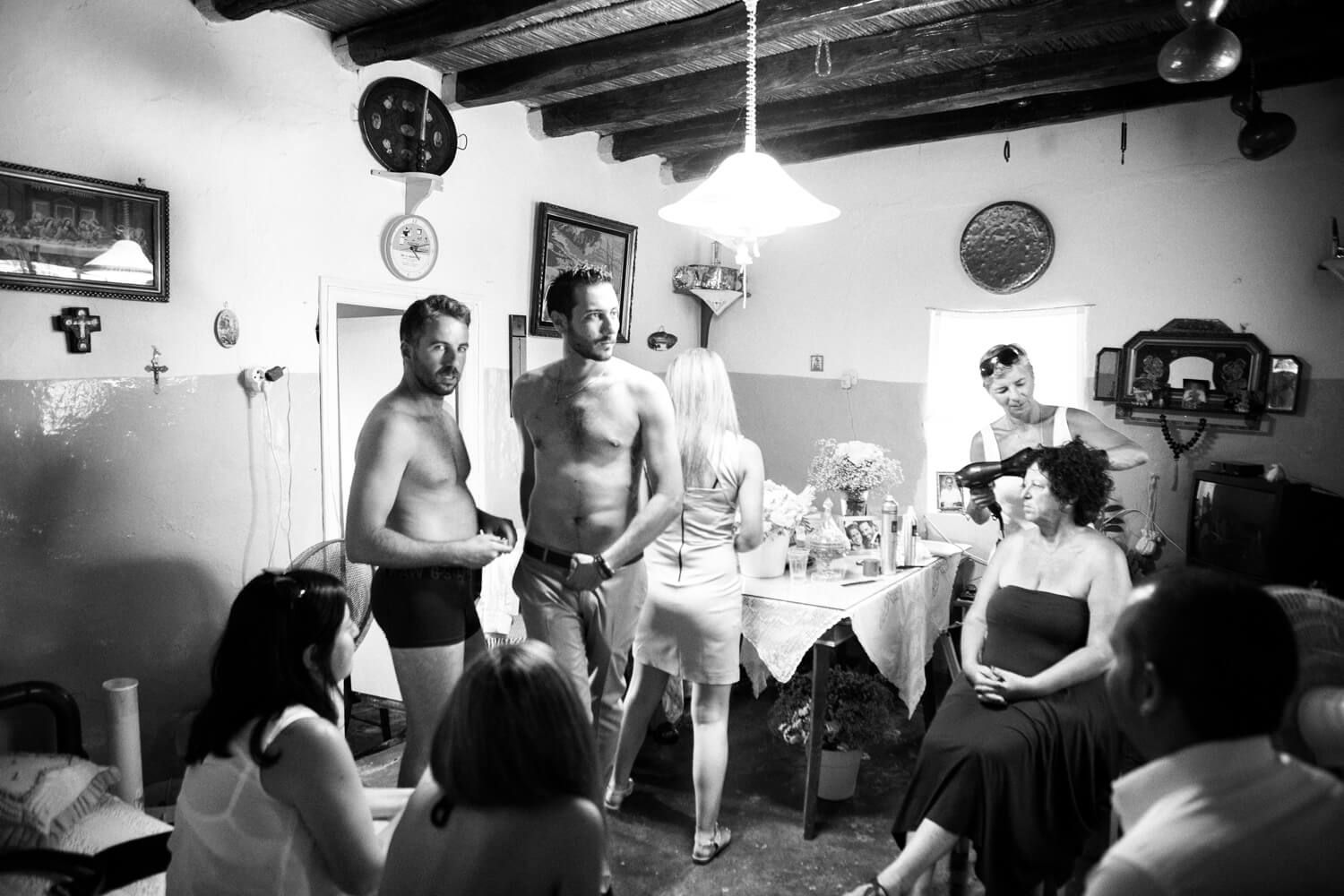 Groom getting ready at his grandmother's traditional house in Pachena Milos