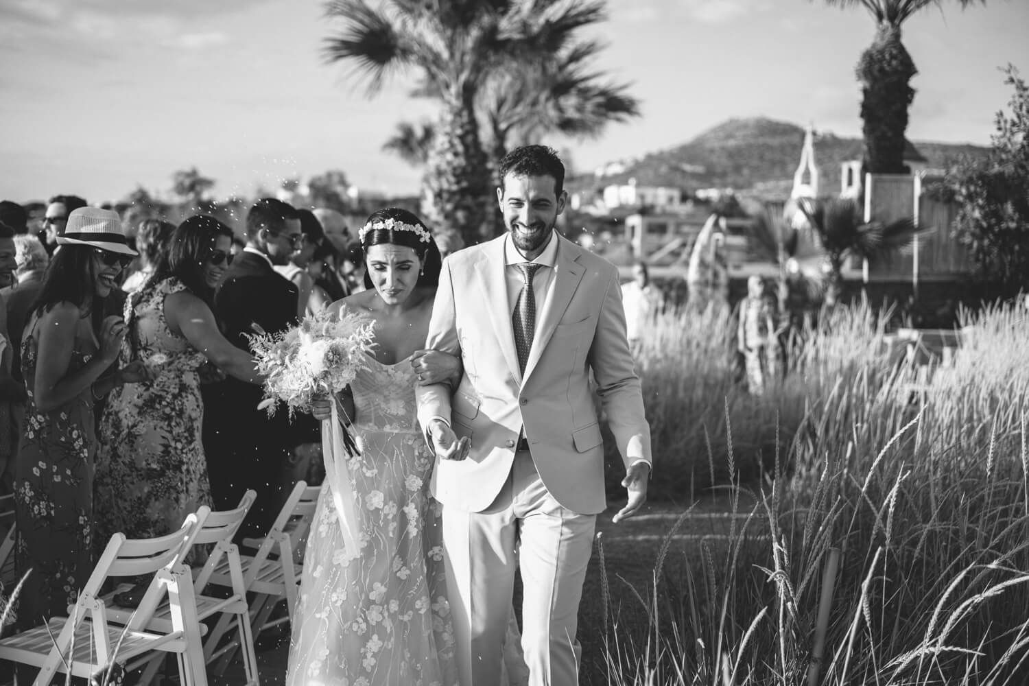Newlyweds walking down the aisle at the seaside Seesoo venue