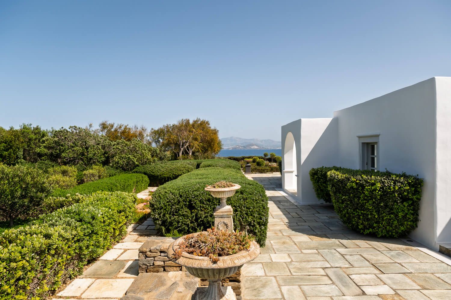 Pristine green lawns contrasting with traditional white architecture
