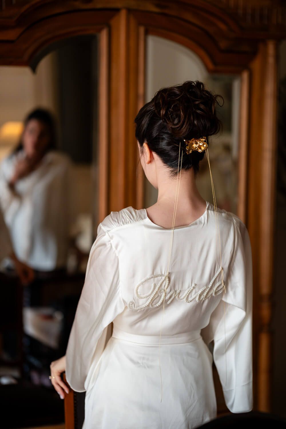 Bride standing in front of a mirror in Syros Greece