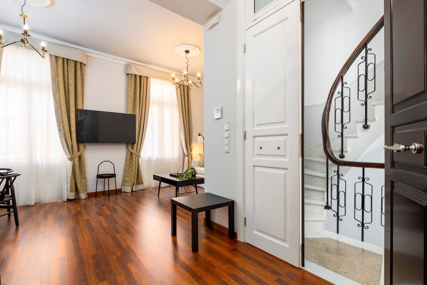Classic Athenian tall windows and wooden floor at Asty Apartments