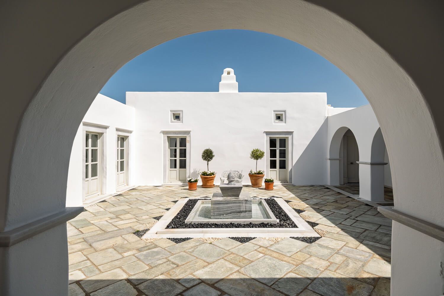 Beautiful inner courtyard with a water fountain in Greece