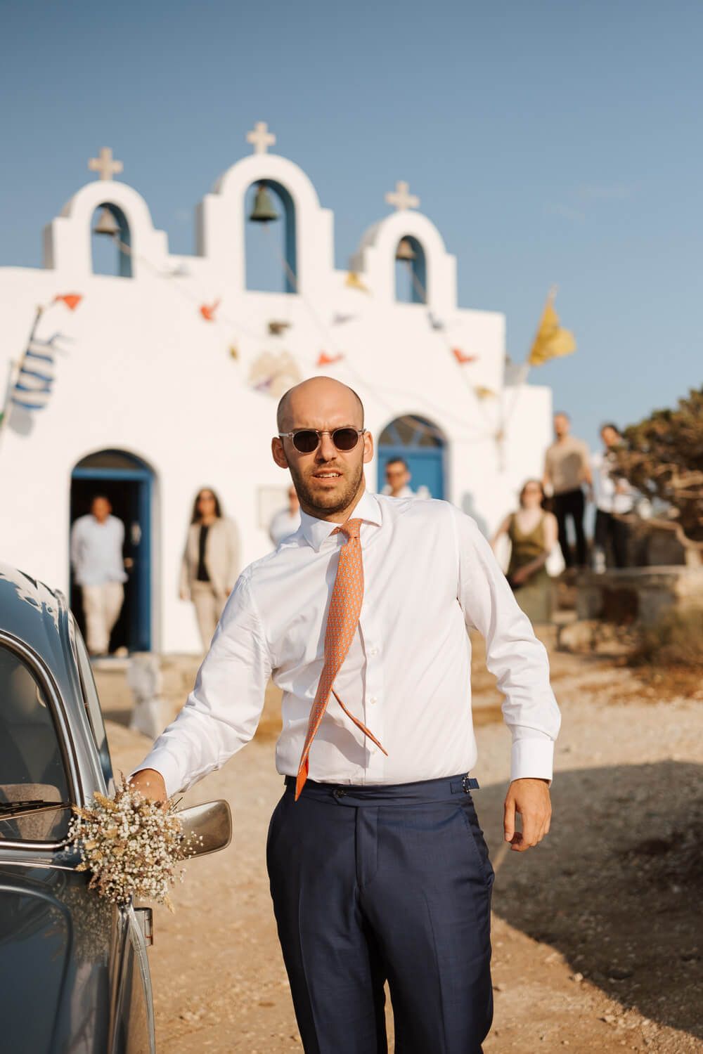 Groom Dimitris arriving at Pyrgaki chapel in a vintage VW Beetle