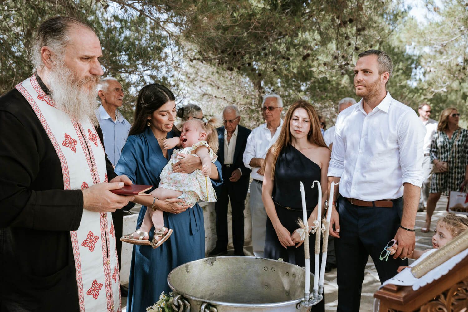 Συγκινημένοι γονείς παρακολουθούν τη βάπτιση της κόρης τους