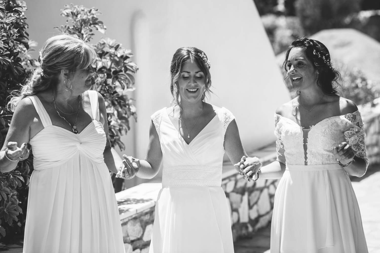 Bride smiling with her bridesmaids before the symbolic ceremony in Paros