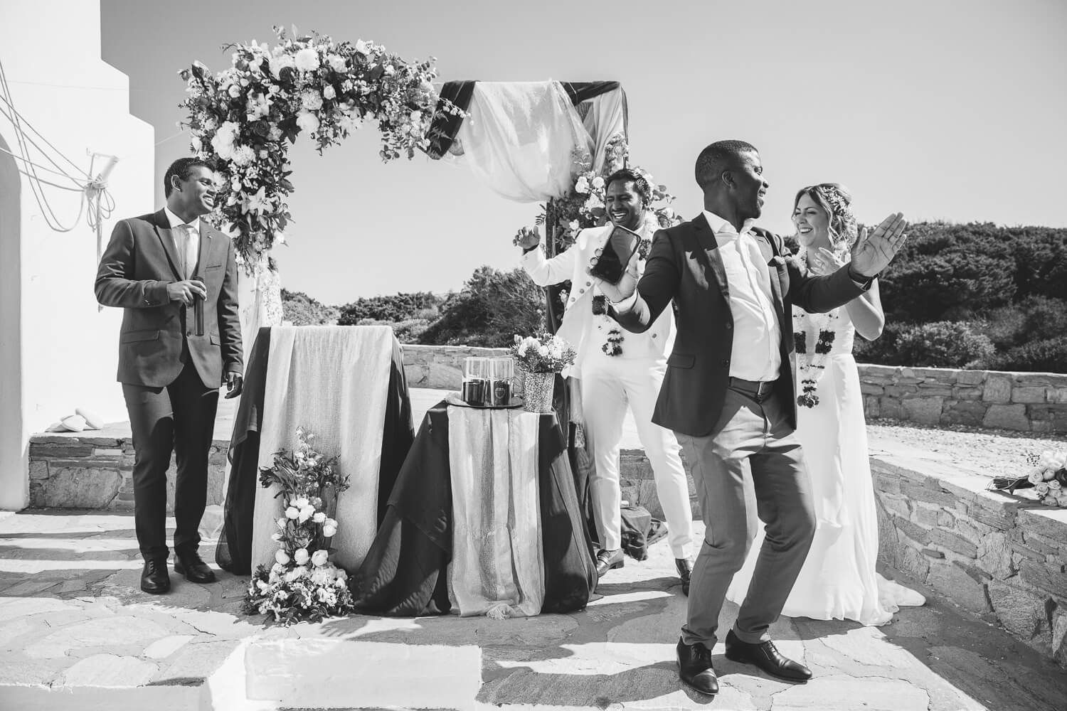 Wide landscape shot of the outdoor wedding ceremony with Aegean Sea views