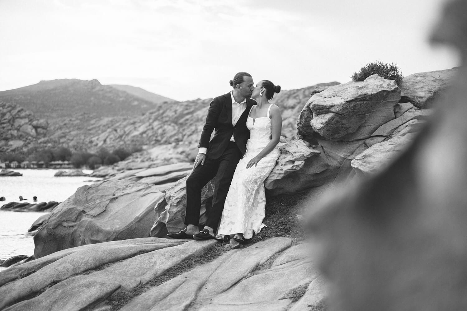 Black and white portrait of the couple hugging after theri elopement at Kolimbithres.