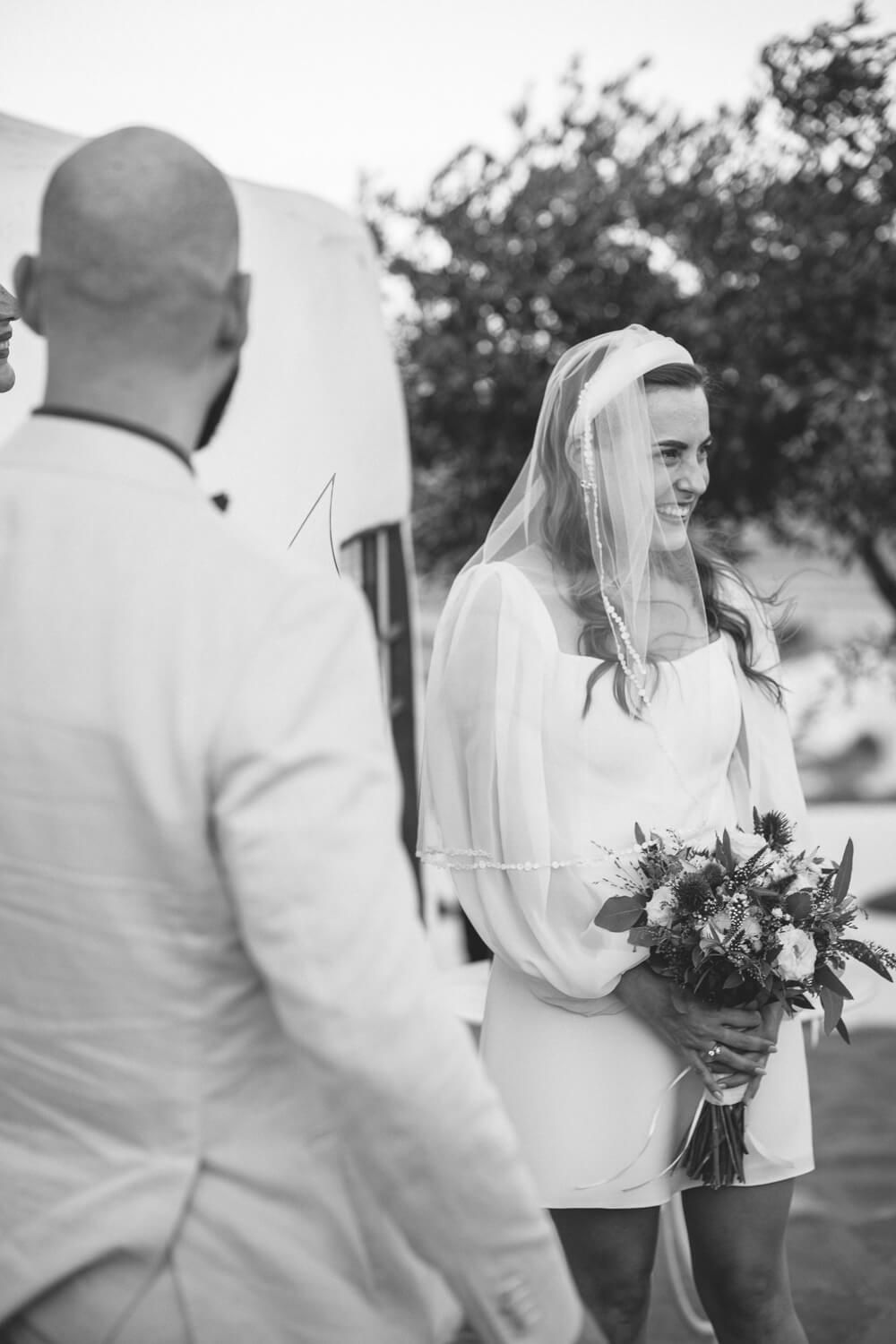 Bride Lisa walking towards the chapel for her intimate Paros micro wedding
