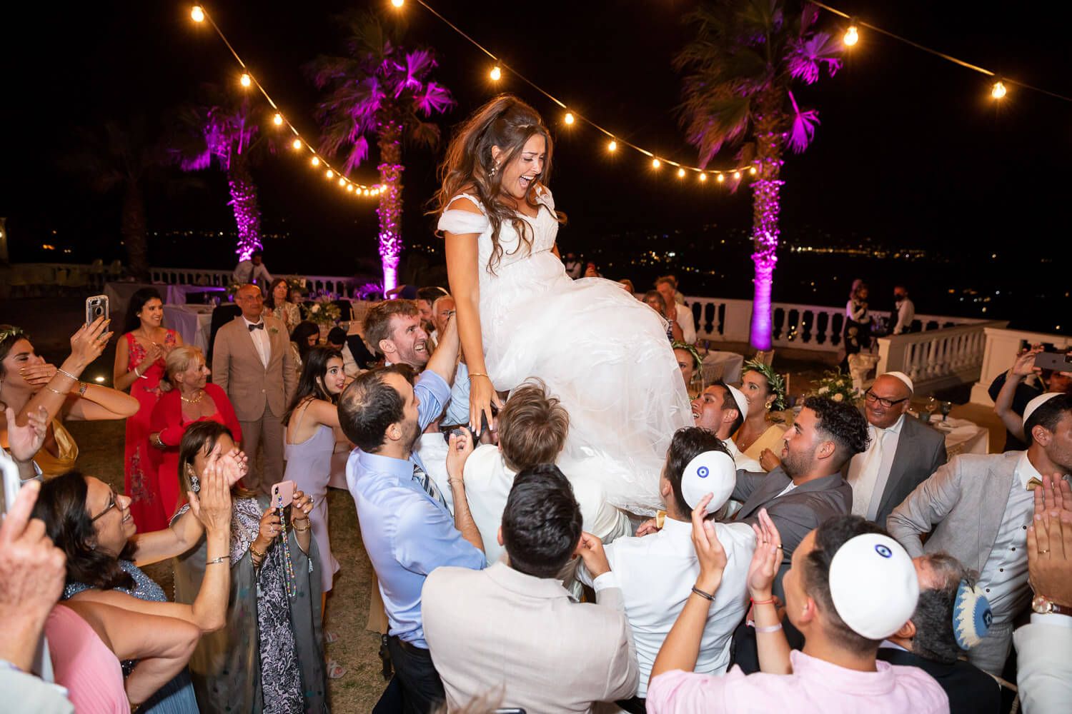 Guests dancing in circles for the traditional Hora at Paros wedding