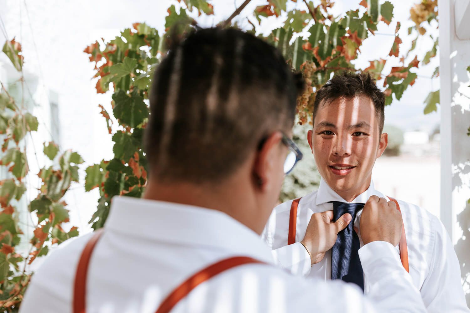 Groom with koumbaroi at a traditional house behind Sunset Restaurant