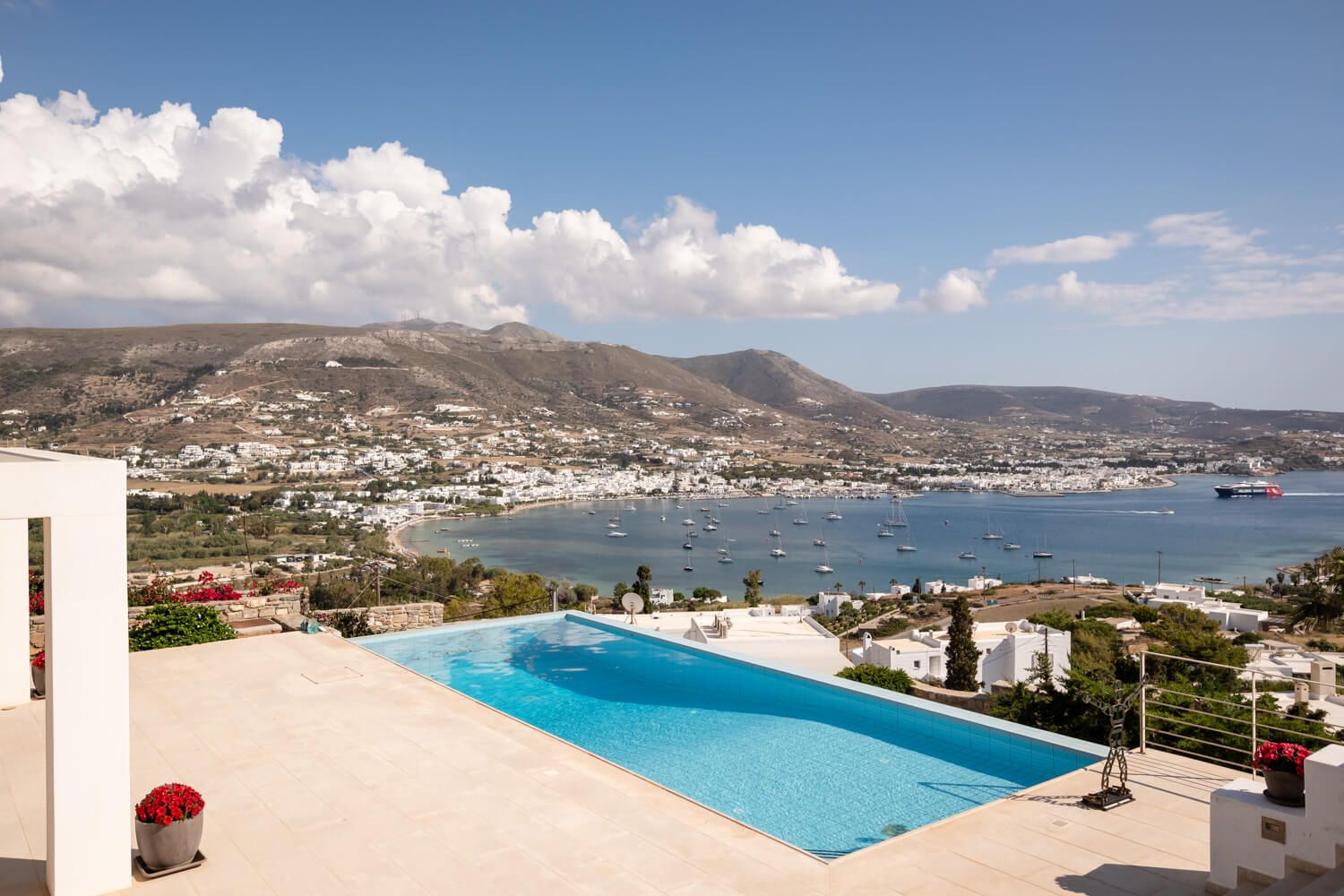 Panoramic view of a luxury villa in Paros overlooking Parikia bay during a bridal preparation.