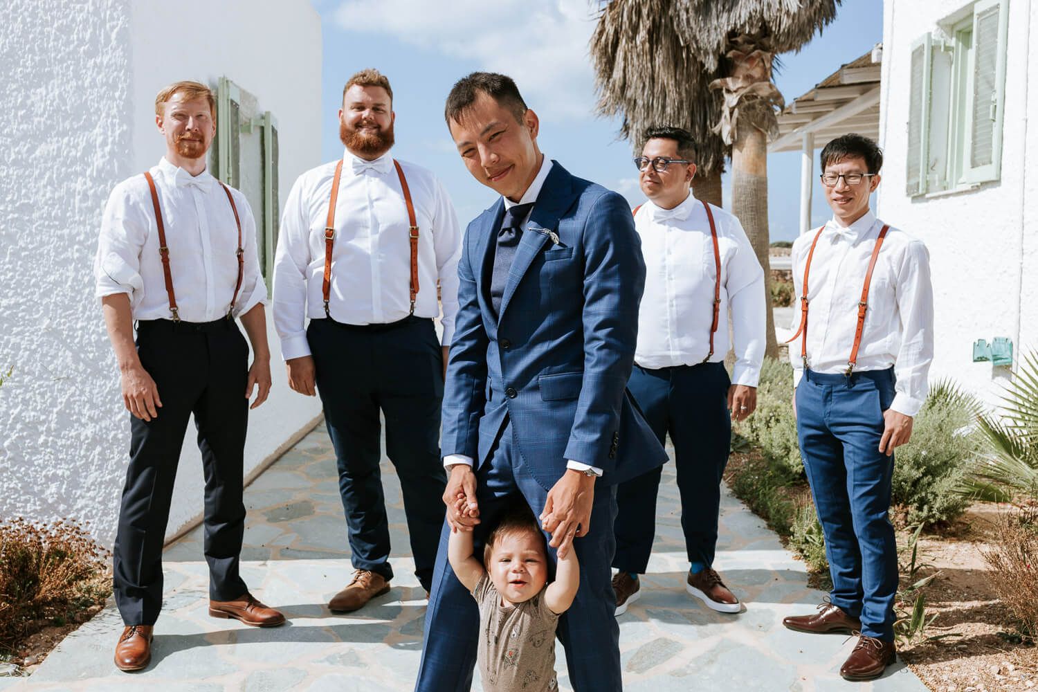 Groom with koumbaroi at a traditional house behind Sunset Restaurant