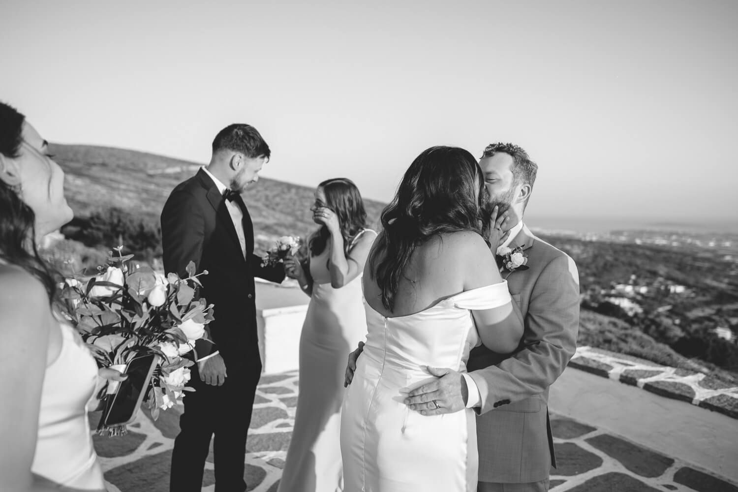 Romantic first kiss at sunset overlooking the Aegean Sea