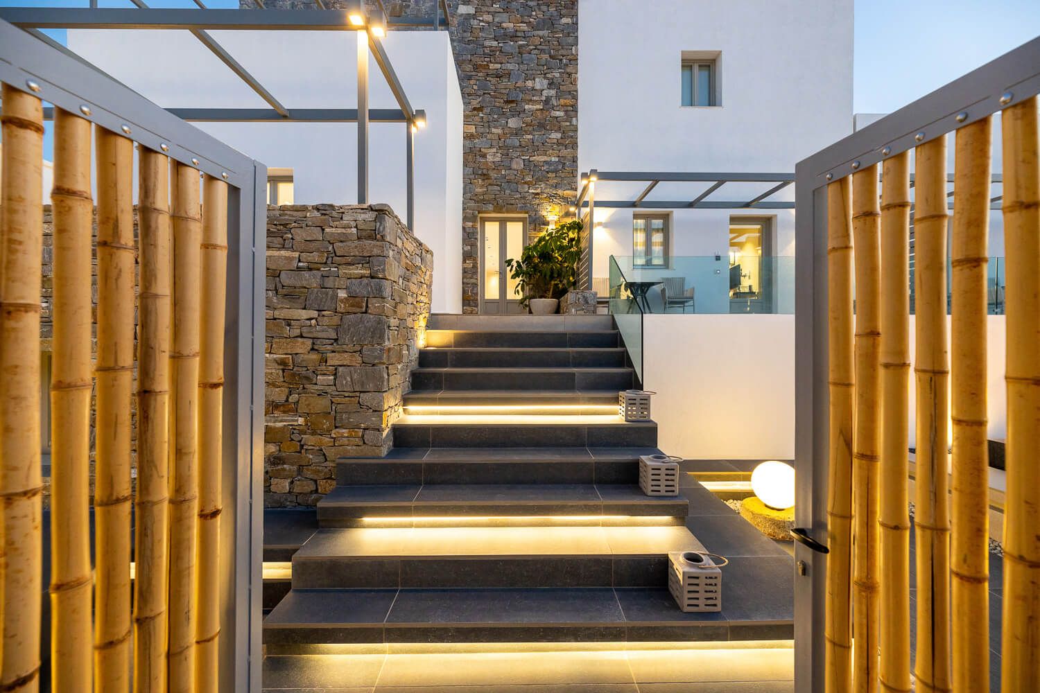 Nighttime architectural framing of a luxury lifestyle property