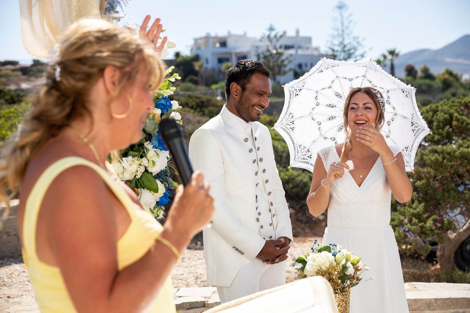 Couple holding hands during their symbolic wedding ceremony at Pyrgaki Paros
