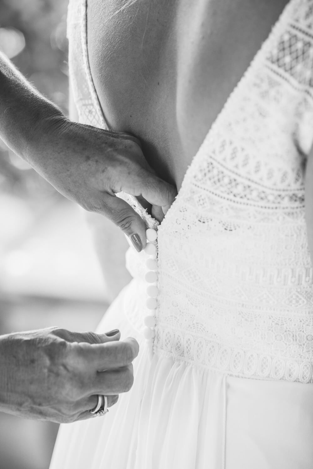 Bride putting on her elegant wedding dress in the Cyclades