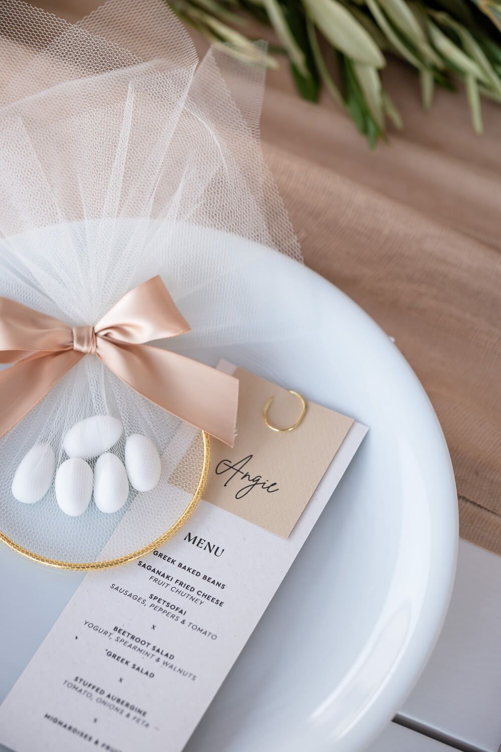 Close up of a personalized menu and a fresh lemon on the reception table