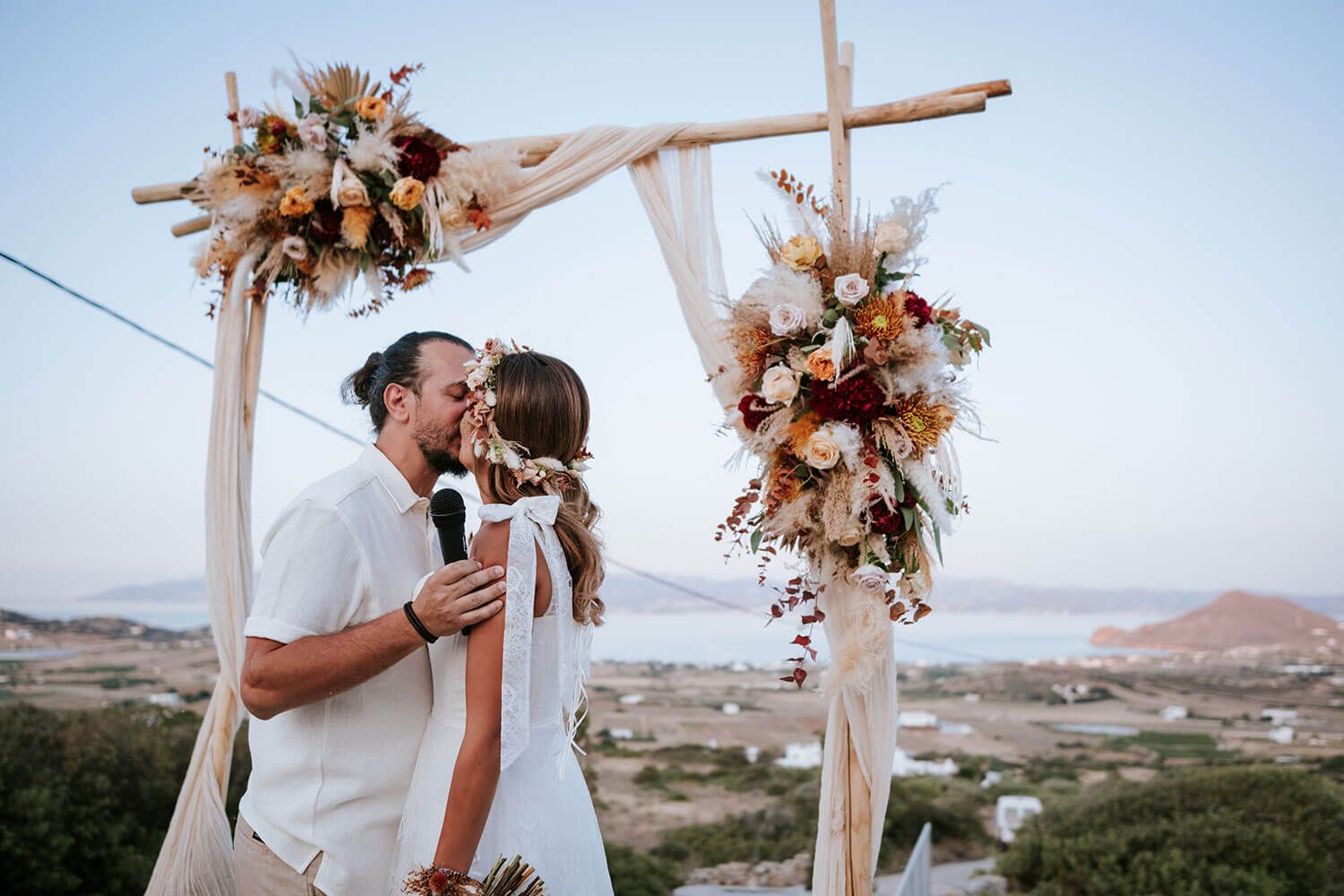 Newlyweds sharing their first kiss as husband and wife at sunset