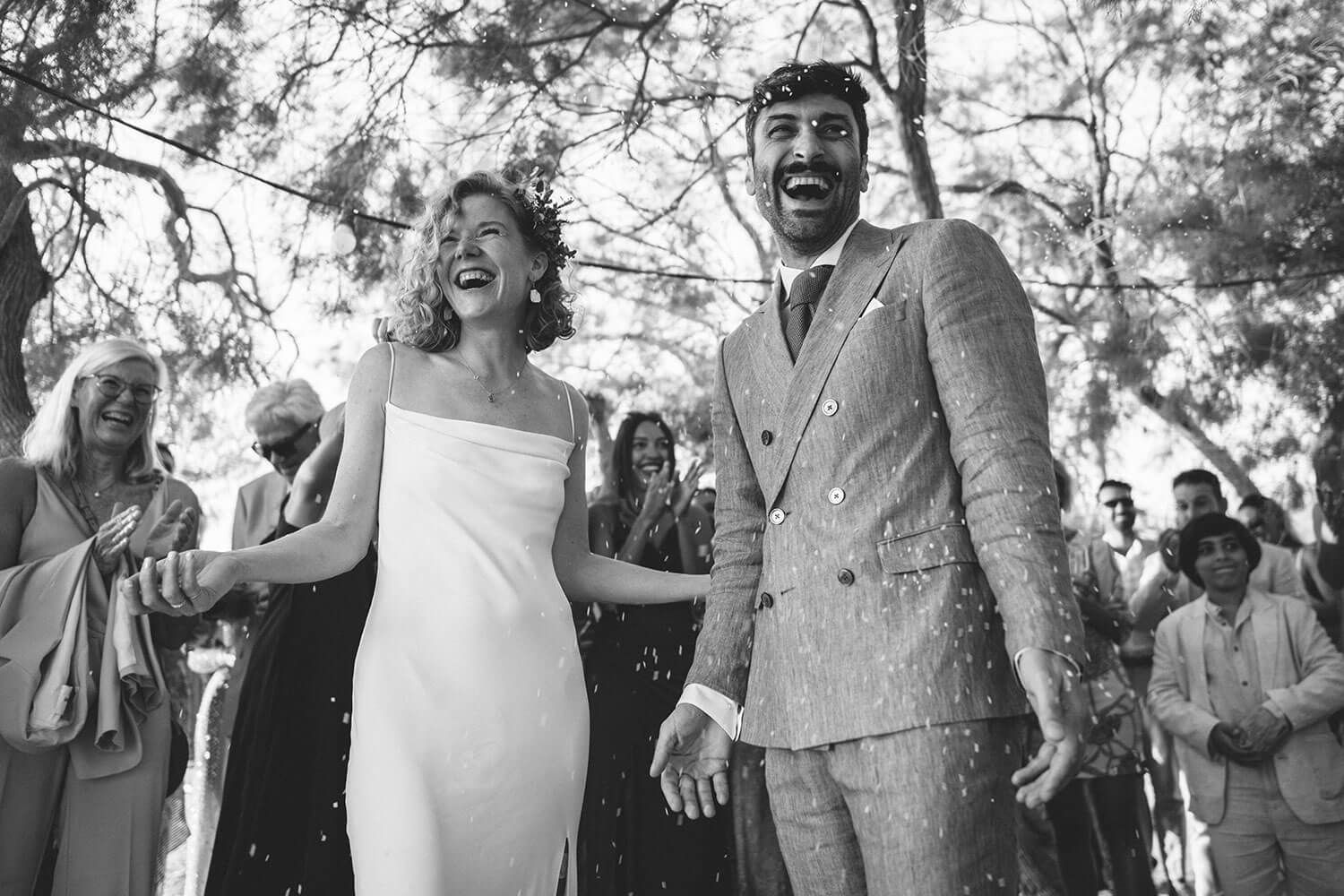 Candid moment of the married couple celebrating by the Aegean Sea