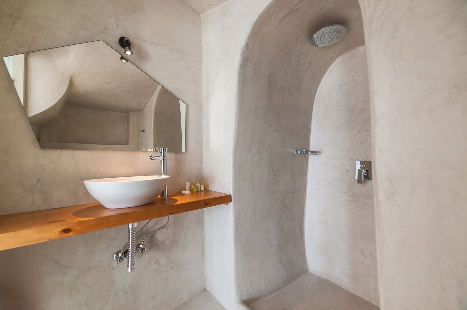 Distinctive cave-style bathroom design featuring premium local materials