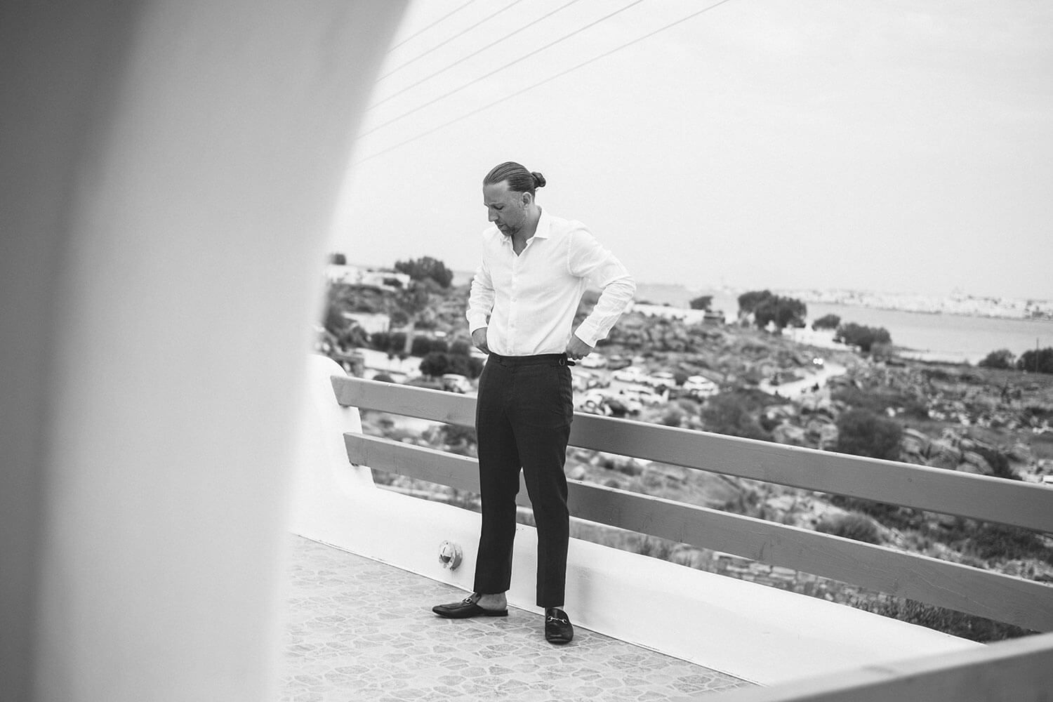 Groom adjusting his suit before his intimate wedding in Paros