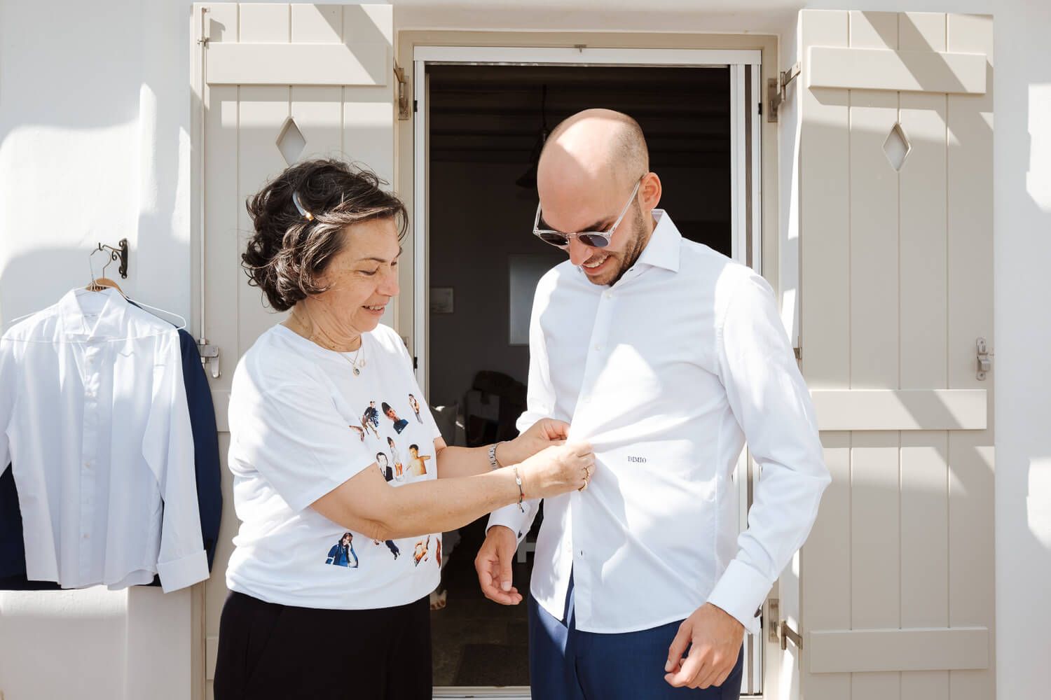 Mother helping Dimitris prepare for his destination wedding in Greece