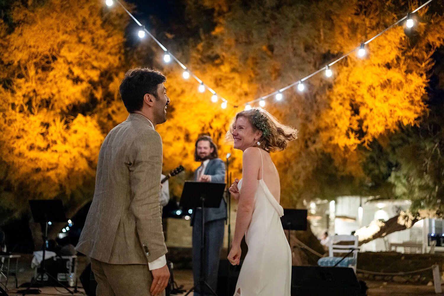 High energy wedding party celebrating at a beachfront restaurant in Greece