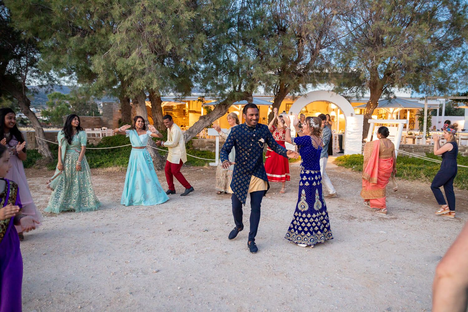 Newlyweds making a grand entrance at their Paros wedding reception