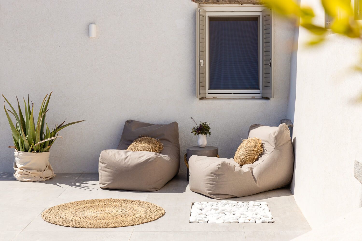 Minimalist Scandinavian interior design with beige cushions and natural decor elements in a bright white space.