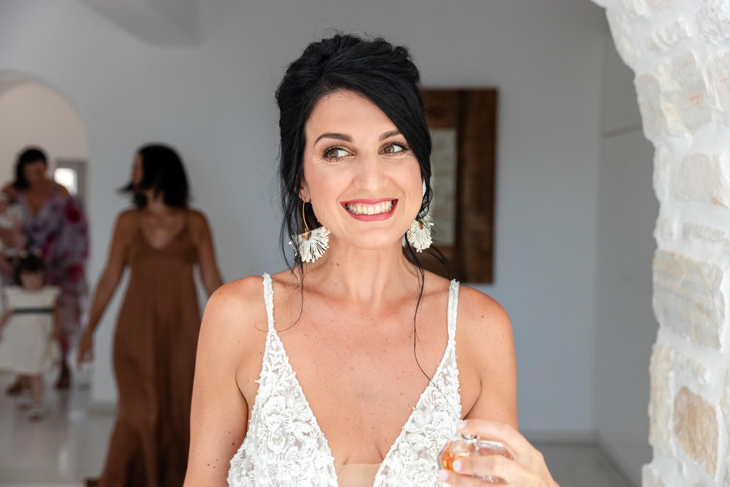 Candid shot of the bride laughing with her family at Villa Aethra