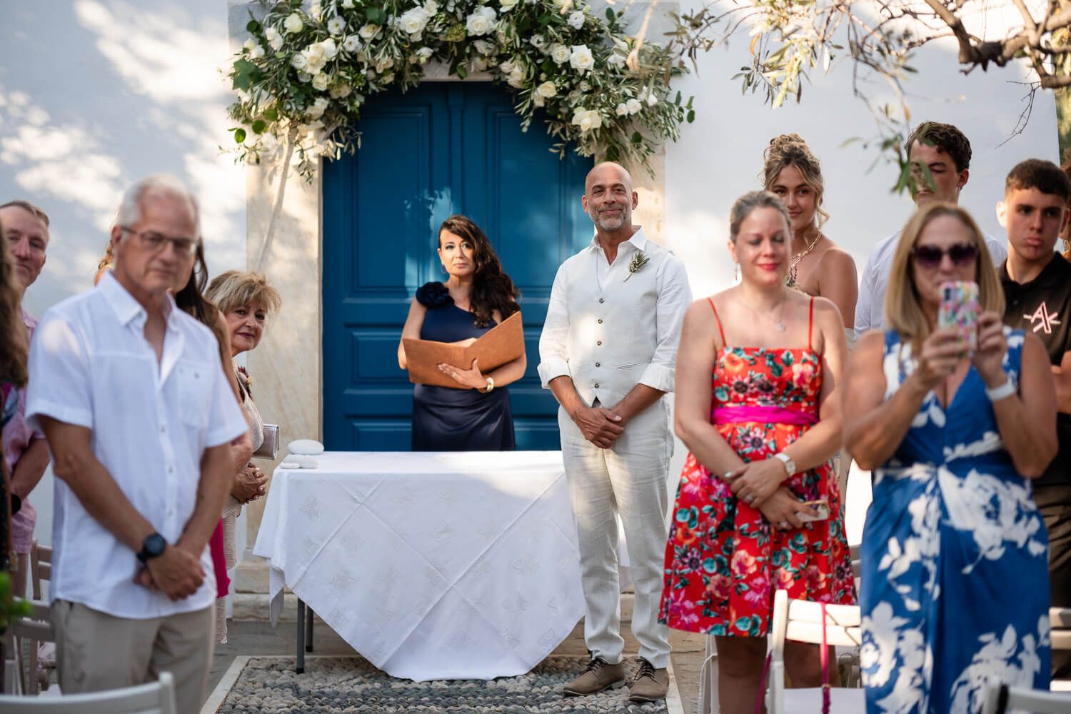 Groom Dean waiting by the chapel at Petra Farm Paros