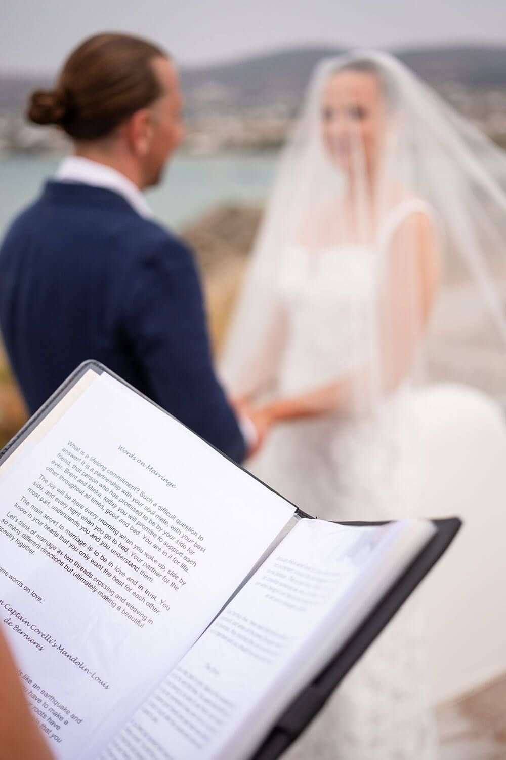 Wedding officiant speaking to the couple under the Greek sun